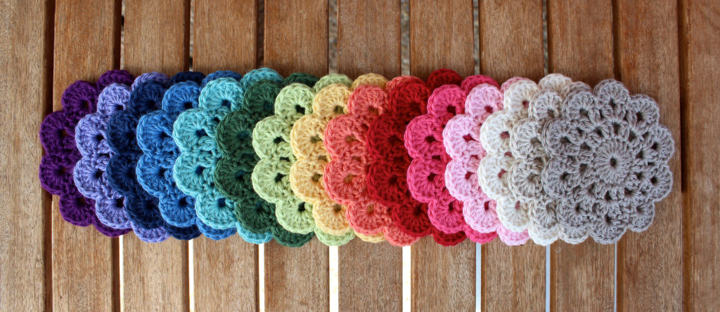 10 petal coasters. Bendigo Woollen Mills 8 ply cotton in Regal, Wild Lavender, French Navy, Sky, Light Teal, Cypress, Honeydew, Daffodil, Peach, Pomegranate, Blush, Pink Rose, Parchment, Latte and Fawn. 
