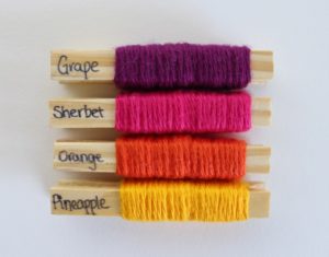 Grape, Sherbet, Orange and Pineapple Crush yarn pegs.